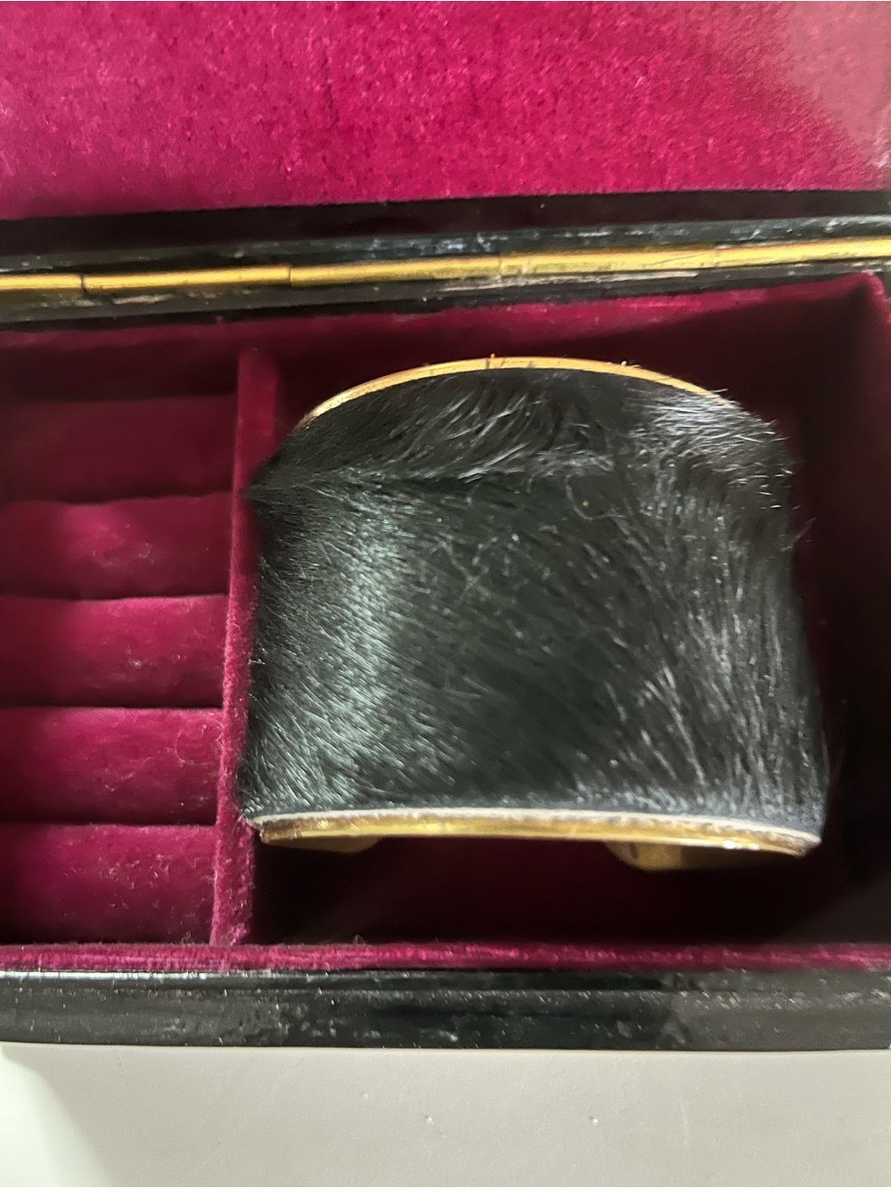 Calf Hair Cuff set into a polished gold 
  tone frame